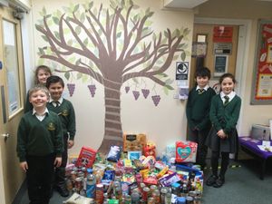 Pupils from St John's Catholic Primary School with their food bank donations