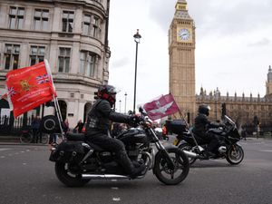 Veterans on motorbikes riding past Big Ben