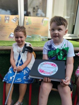 The children at Kids Planet Bromley displaying our eco award book which we are very proud of.