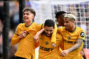 Jorgen Strand Larsen of Wolverhampton Wanderers celebrates scoring his team's third goal with teammates Rayan Ait-Nouri and Joao Gomes (Photo by Dan Mullan/Getty Images)