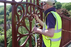 Sign-writer Phil Barber picks out the lettering on the bridge