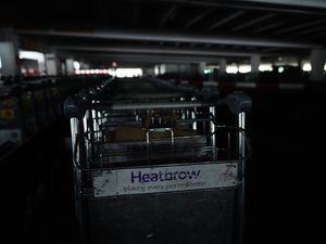 Trollies in the unlit car park at Heathrow terminal four in London