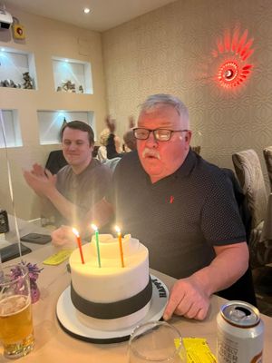 Ian Reeves blowing out the candles on his birthday cake