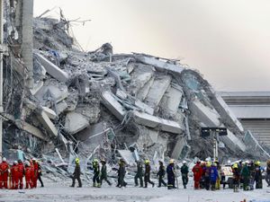 Rescue workers at the site of the building collapse