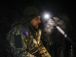 A Ukrainian serviceman sits in a shelter