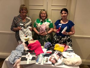 Soroptimists Lynne Tuckley, Jill Mason, Elena Bratu with some of the donated items