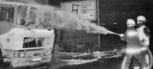 Firefighters douse the tanker with foam.