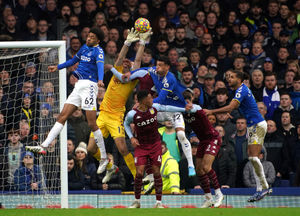 Aston Villa goalkeeper Emiliano Martinez (second left) saves a shot during the Premier League match