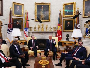 Boom mics are held over Donald Trump during his meeting with Sir Keir Starmer, alongside US Vice President JD Vance and Foreign Secretary David Lammy, in the Oval Office