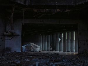 A tent sheltering displaced Palestinians stands in a destroyed hallway