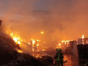 Supporting image for story: 30 firefighters still at plant where thousands of tons of waste went up in flames