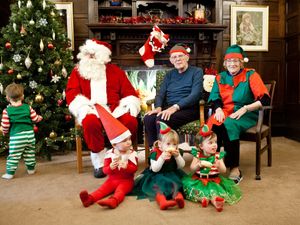 Residents Maurice Kitchen and Pat Holland with Father Christmas and some of the toddlers