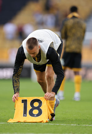 Sasa Kalajdzic lays a Number 18 shirt on the pitch in Jota's honour