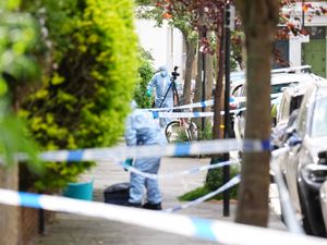 A forensics officer is seen in Kentish Town, north London