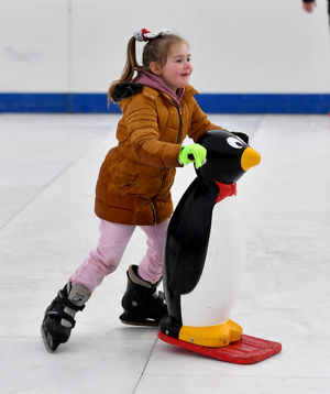 Ellie-May Coughlin, aged five, has fun with a penguin