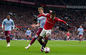 Aston Villa's Calum Chambers battles for the ball with Manchester United's Marcus Rashford