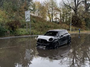 Supporting image for story: Burnt-out car left in middle of floodwater after electrical fault starts blaze