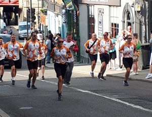The Queen's Baton is carried along Castle Gates in Shrewsury. Photo: @ShrewsburyCops