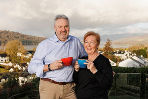 Omaze winners Catherine & Chris Carwardine outside their £3m Lakeside home