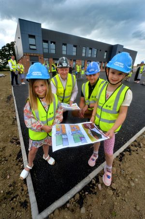 Seeing the new school up close were four-year-olds Alma and Nora, with Phil Gibbs and Sam Aiston