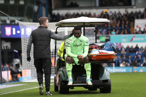 Daryl Dike is helped off the Portman Road pitch in tears after he ruptured an Achilles tendon for the second time in nine months. The rupture was the opposite leg to his injury from last season. (Photo by Adam Fradgley/West Bromwich Albion FC via Getty Images).