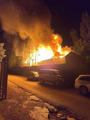 Huge flames could be seen coming out of the roof of the boatyard. Photo: West Midlands Fire Service
