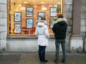 People looking in an estate agent's window