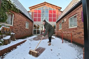 Tara gets the Perton Library entrance ready for visitors