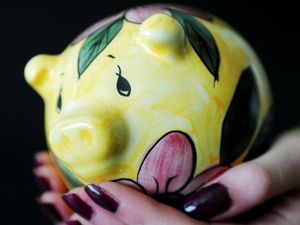 A piggy bank being held