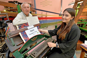 Museum of Carpet assistant Emily Gilbert with weaver Cedric Hardwick with the Lamb Jaquard stamping machine