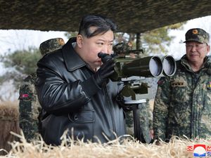 Photo provided by the North Korean government showing leader Kim Jong Un, left, supervising artillery firing drills