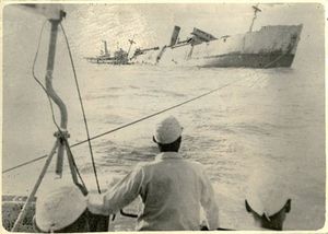 This is believed to be the only surviving photograph of the sinking of the Lisbon Maru, taken from a Japanese naval ship around 8am on 2 October 1942.(National Archives) 