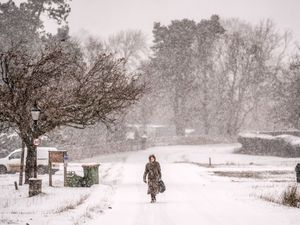 Woman walking through snow