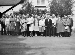 The WRVS (Women's Royal Voluntary Service) Luncheon Club of Bishop's Castle celebrated its first anniversary in September 1985 with a special lunch which was cooked by Mrs O Cund. A special first birthday cake was made and members are seen holding it in the centre of the photograph. 