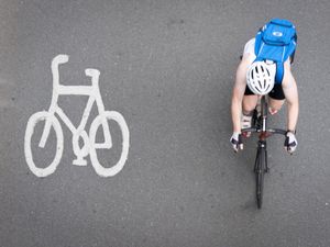 A cyclist passes a painted cycle lane icon in London