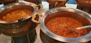 Big pots of curry, dhal and aloo are present in the Indian section