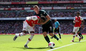 Arsenal's Joe Willock (left) and Burnley's Chris Wood battle for the ball.