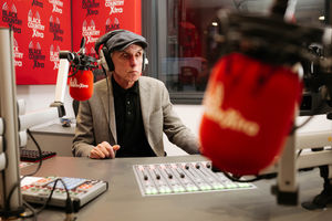 Brian Dakin records a show behind the desk of the Billy Spakemon studio