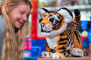 Louise Edwards, 9, plays with the FurReal Roarin' Tyler 