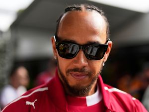 Lewis Hamilton walks through the paddock ahead of qualifying