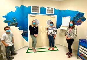 Mural artist Rory McCann with Karen Cummings, paediatric recovery nurse; Claire Heathfield, recovery manager; and Heather Thomas-Bache, League of Friends office manager and head of voluntary services, in front of the Finding Nemo mural