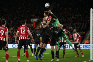 Wes Foderingham of Sheffield United punches the ball clear of Andy Carroll of West Bromwich Albion during the Sky Bet Championship match between Sheffield United and West Bromwich Albion at Bramall Lane on February 9, 2022 in Sheffield, England. (Photo by Adam Fradgley/West Bromwich Albion FC via Getty Images).
