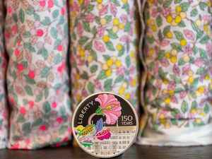 A coin against fabric rolls