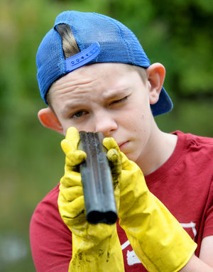 Logan, age 14, with the barrel of a sawn-off shotgun