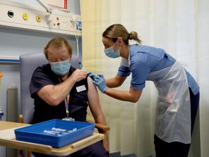 Deputy charge nurse Katie McIntosh administers the first of two Pfizer/BioNTech Covid-19 vaccine jabs to Andrew Mencnarowski at the Western General Hospital in Edinburgh