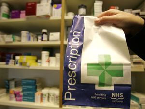 A prescription being collected from a pharmacy