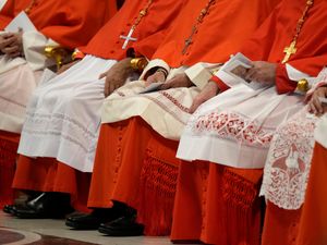 Cardinals sitting in a line from necks down
