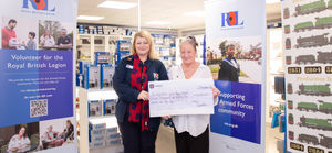 Claire Lewis, the Poppy Appeal Manager for North Wales, receiving a cheque from Dapol factory manager, Samantha Jones.
