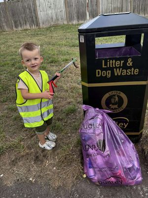 One of the children spending time collecting rubbish from the Fens Pool Nature Reserve.