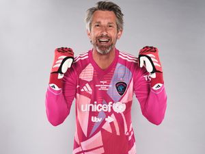 Edwin van der Sar smiles and clenches his fists in celebration